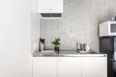 a kitchen with white cabinets and a sink at Cozy 1BR Apt in Asakusa-8 min walk Naka Okachimachi station in Tokyo