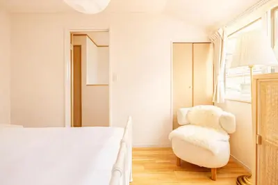 a bedroom with a bed and a chair at Shinjuku Large Entire 3Story House for 9 Near 2 Stations in Tokyo