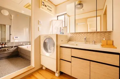 a bathroom with a sink and a washing machine at Shinjuku Large Entire 3Story House for 9 Near 2 Stations in Tokyo