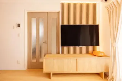 a living room with a tv on top of a cabinet at Shinjuku Large Entire 3Story House for 9 Near 2 Stations in Tokyo