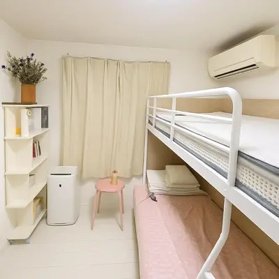 a small room with a bunk bed and a pink stool at MIKI HOUSE Families and groups welcome \u65b0\u5c0f\u5ca9 private in Tokyo