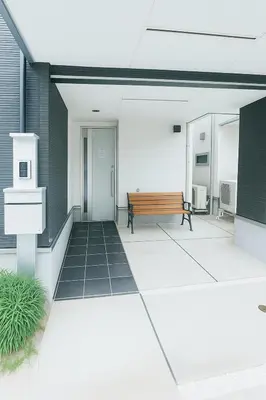 a patio with a bench in a building at MIKI HOUSE Families and groups welcome \u65b0\u5c0f\u5ca9 private in Tokyo