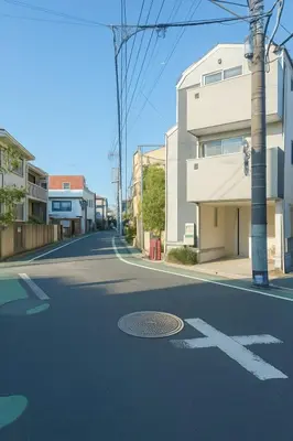 an empty street with a building on the side of the road at MIKI HOUSE Families and groups welcome \u65b0\u5c0f\u5ca9 private in Tokyo