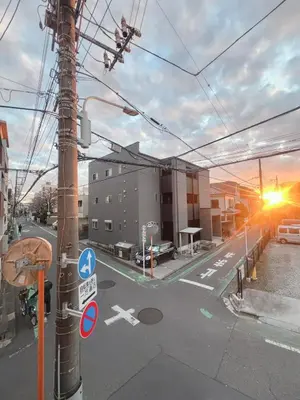 an empty street with a pole with a street sign at MIKI HOUSE Families and groups welcome \u65b0\u5c0f\u5ca9 private in Tokyo