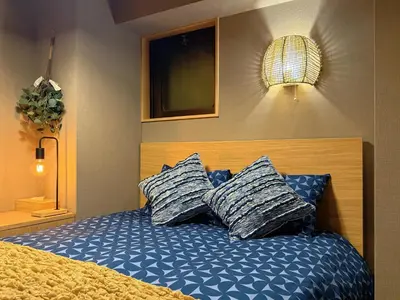 a bedroom with a bed with two pillows on it at Shinjuku Station kabukicho 2minutes big House in Tokyo