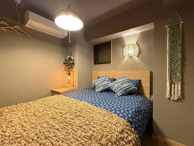 a bedroom with a bed with two pillows on it at Shinjuku Station kabukicho 2minutes big House in Tokyo