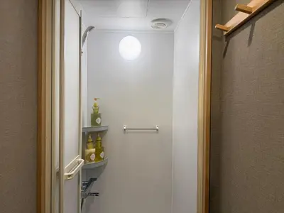 a bathroom with a shower and a toilet with a light at Shinjuku Station kabukicho 2minutes big House in Tokyo