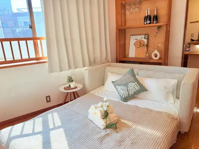 a small bedroom with a bed with flowers on it at mukai Apt - 5 min walk to Itabashi subway 1stop 3min to Ikebukuro in Tokyo