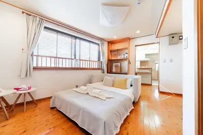 a bedroom with a bed with two towels on it at mukai Apt - 5 min walk to Itabashi subway 1stop 3min to Ikebukuro in Tokyo
