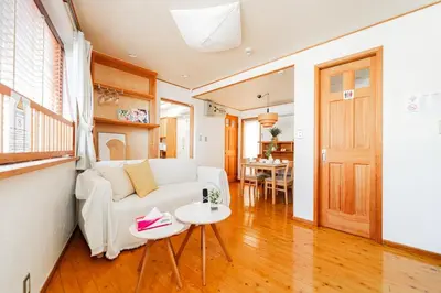 a living room with a white couch and a table at mukai Apt - 5 min walk to Itabashi subway 1stop 3min to Ikebukuro in Tokyo