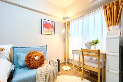 a bedroom with a blue bed and a desk at 21sqm cozy studio 5min to JR sta Great Access to Shinjuku Shibuya in Tokyo