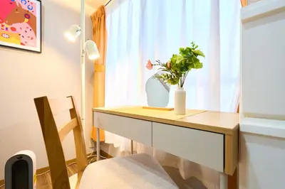 a table with a vase on it next to a window at 21sqm cozy studio 5min to JR sta Great Access to Shinjuku Shibuya in Tokyo