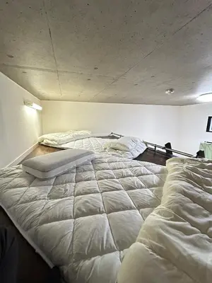 a large bed in a room with two bedsyss at HillTop Sendagi 102 in Tokyo