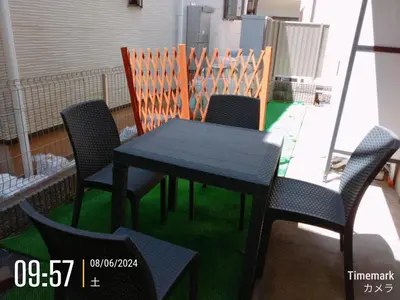 a black table and chairs on a balcony at HillTop Sendagi 102 in Tokyo