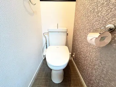 a bathroom with a white toilet and a toilet paper dispenser at HillTop Sendagi 102 in Tokyo