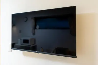 a flat screen tv hanging on a wall at Sora Stay Shinjuku in Tokyo
