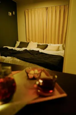 a hotel room with two beds and a tray of food at Sora Stay Shinjuku in Tokyo