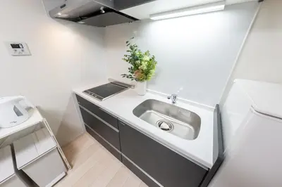 a kitchen with a sink in a small room at Sora Stay Shinjuku in Tokyo