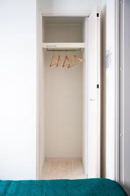 a bedroom with a closet with hangers at Sora Stay Shinjuku in Tokyo