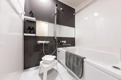 a bathroom with a shower and a toilet and a sink at Sora Stay Shinjuku in Tokyo