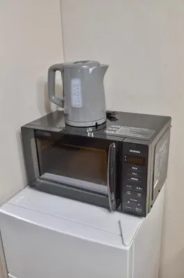a microwave with a coffee pot on top of it at Edo Art Hotel in Tokyo