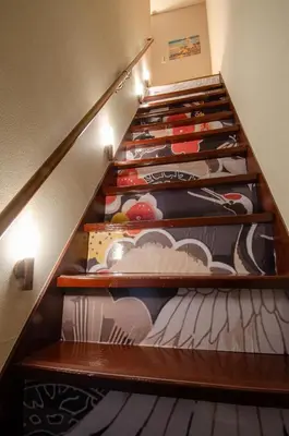 a stairway with wooden shelves filled with shoes at Edo Art Hotel in Tokyo