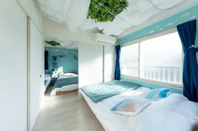 a bedroom with a bed and a window at Tsumugi Yado \u897f\u845b\u897f in Tokyo