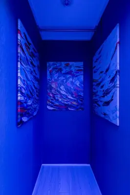 a blue room with two paintings on the wall at Tsumugi Yado \u897f\u845b\u897f in Tokyo
