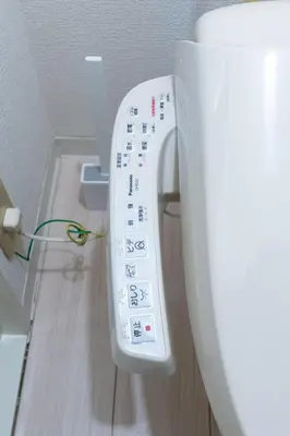 a close up of a toilet with a remote control at Tsumugi Yado \u897f\u845b\u897f in Tokyo
