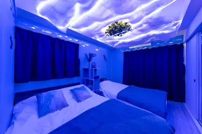 a bedroom with a bed with a blue ceiling at Tsumugi Yado \u897f\u845b\u897f in Tokyo