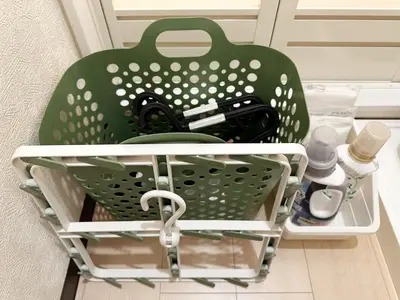 a green basket sitting on the floor in a room at The Travelers Court Bunkyo II in Tokyo
