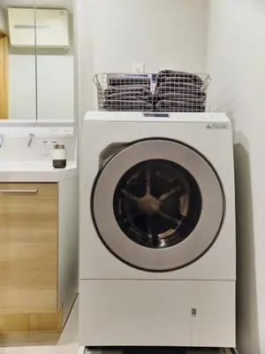 a washing machine in a kitchen next to a sink at NEW Hotel Komugi Skytree - modern Japanese-style guesthouse near Asakusa & Skytree 3mins, whole house rental perfect for large groups up to 14pax in Tokyo