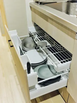 an open dishwasher with plates and dishes in it at NEW Hotel Komugi Skytree - modern Japanese-style guesthouse near Asakusa & Skytree 3mins, whole house rental perfect for large groups up to 14pax in Tokyo