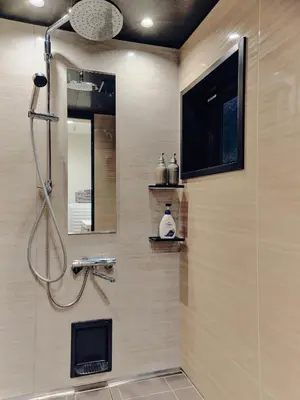 a bathroom with a shower with a tv on the wall at NEW Hotel Komugi Skytree - modern Japanese-style guesthouse near Asakusa & Skytree 3mins, whole house rental perfect for large groups up to 14pax in Tokyo