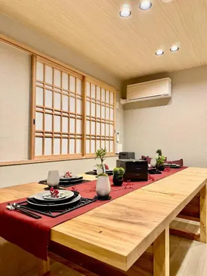 a large room with a table with a red table cloth at NEW Hotel Komugi Skytree - modern Japanese-style guesthouse near Asakusa & Skytree 3mins, whole house rental perfect for large groups up to 14pax in Tokyo