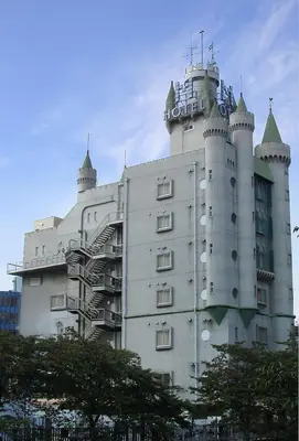 a large white building with a clock tower on it at Meguro Emperor (Adult Only) in Tokyo