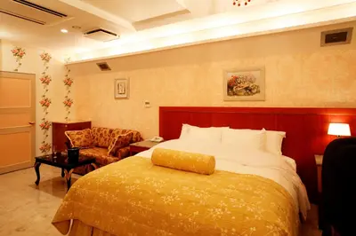 a hotel room with a bed and a chair at Meguro Emperor (Adult Only) in Tokyo