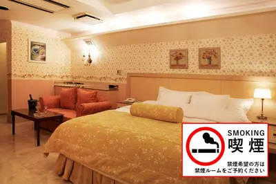 a hotel room with a bed and a chair at Meguro Emperor (Adult Only) in Tokyo