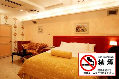 a hotel room with a bed and a no smoking sign at Meguro Emperor (Adult Only) in Tokyo
