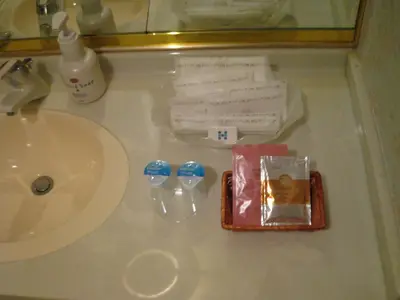 a bathroom counter with a sink and a tray of tooth brushes at Meguro Emperor (Adult Only) in Tokyo