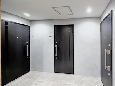 a row of elevators with black doors in a room at ISSHUKU Noma \u5317\u65b0\u5bbfI -202 Triple Room in Tokyo