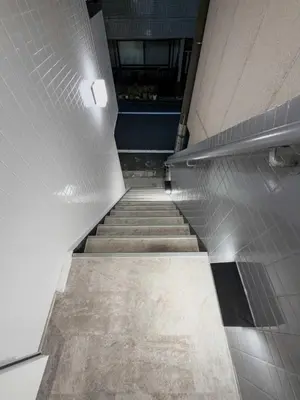 a hallway with stairs in a building with a light at ISSHUKU Noma \u5317\u65b0\u5bbfI -202 Triple Room in Tokyo
