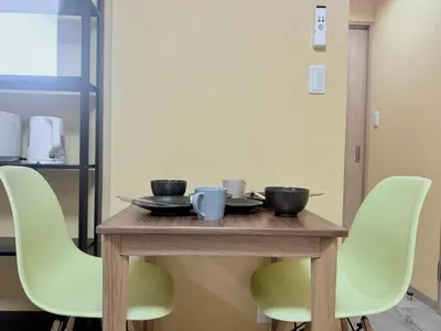 a wooden table with green chairs around it at Tokyo Stay Itabashi #202 in Tokyo