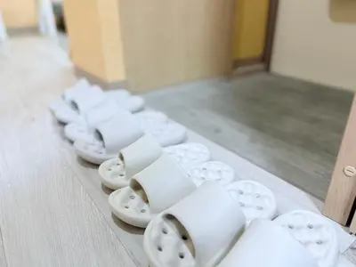 a row of white cups and plates on a table at Tokyo Stay Itabashi #202 in Tokyo