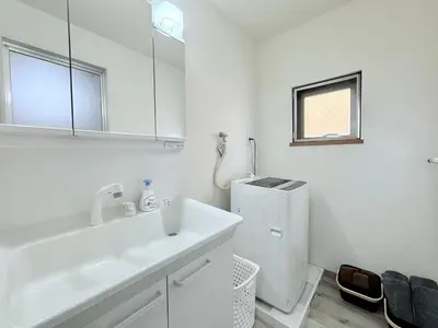 a white bathroom with a sink and a mirror at Tokyo Stay Itabashi #202 in Tokyo