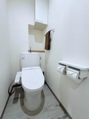 a bathroom with a toilet with a phone on the wall at Tokyo Stay Itabashi #202 in Tokyo