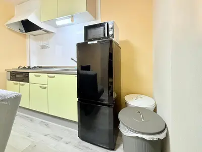 a kitchen with a refrigerator and a trash can at Tokyo Stay Itabashi #202 in Tokyo