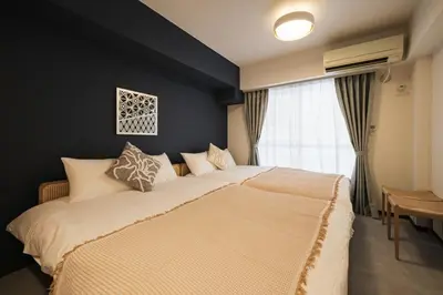 a bedroom with a large bed and a window at White court Shinjuku203 in Tokyo