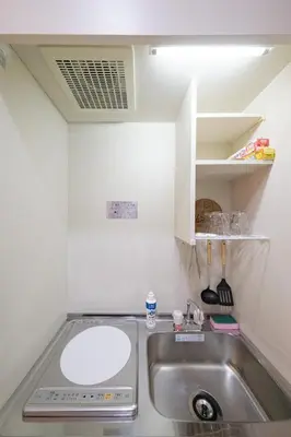 a small kitchen with a sink and a counter at White court Shinjuku203 in Tokyo