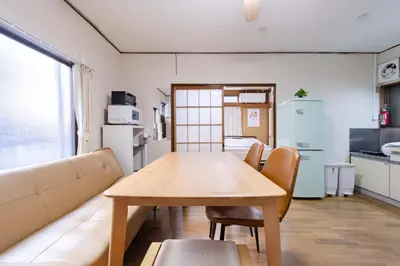 a living room with a table and a couch at Sanyouso in Tokyo